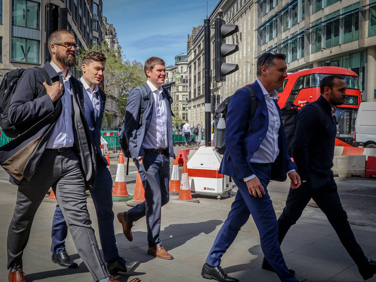 Business meeting etiquette in UK: professionals shaking hands in a London conference room